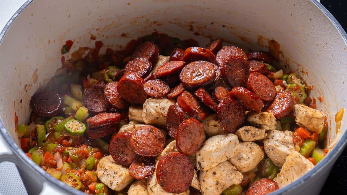 chicken and sausage added to the pot