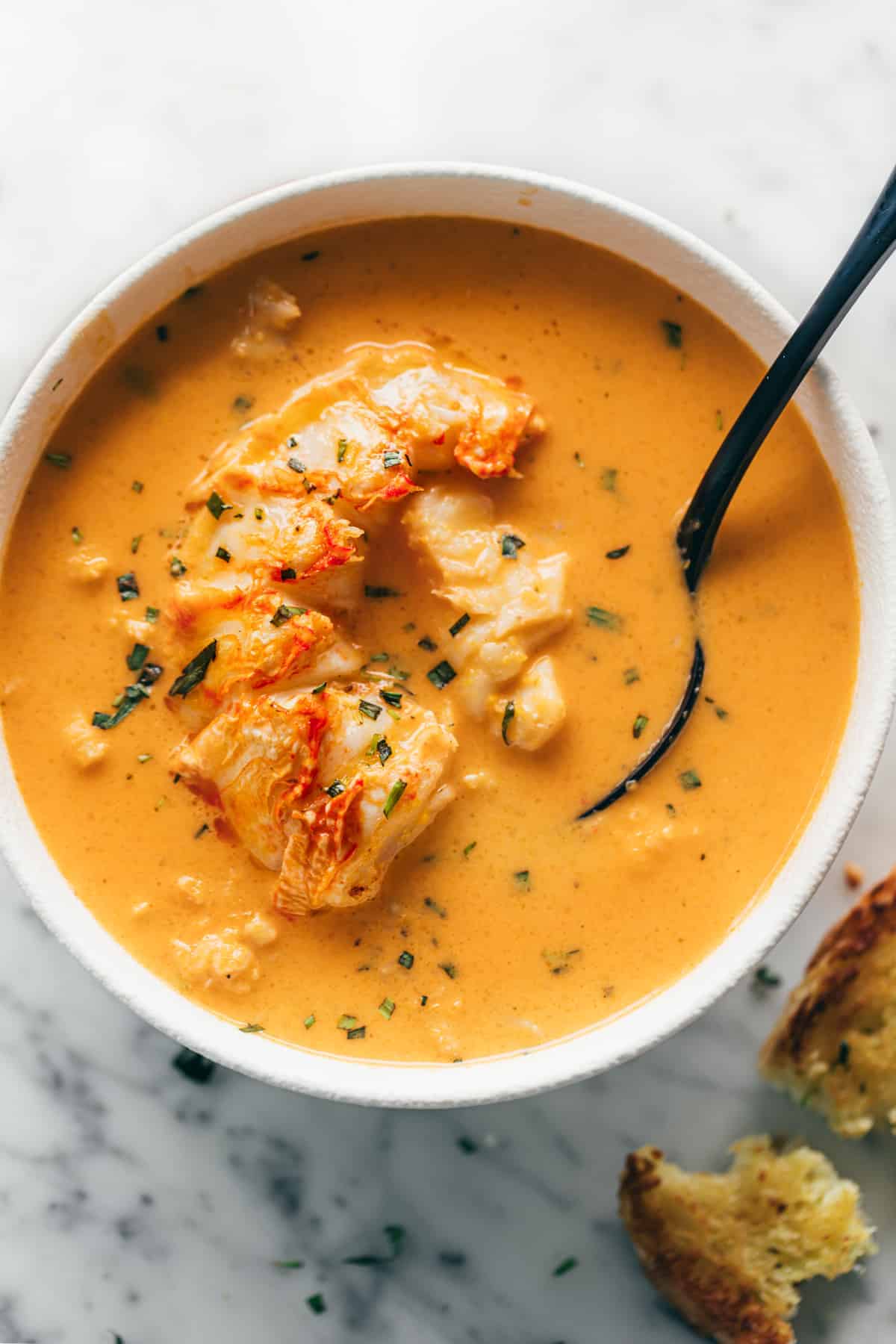 Lobster Bisque recipe made easy with big chunks of garlic butter lobster tails in every bite and a quick homemade stock! cafedelites.com #lobster #lobstertails #lobsterbisque
