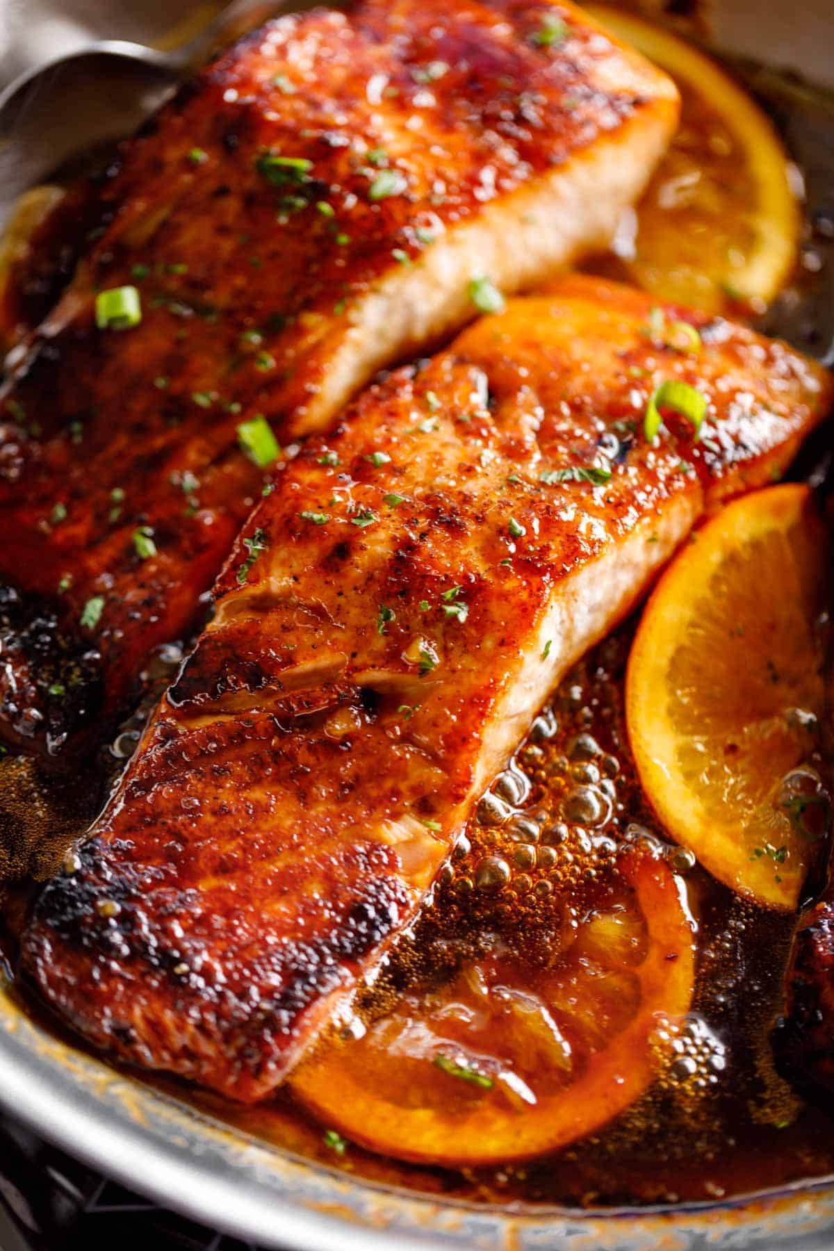 Crispy Honey Orange Glazed Salmon fillets are pan-fried in the most beautiful honey-orange-garlic sauce, with a splash of soy for added flavour! | cafedelites.com