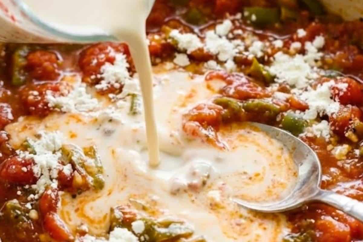 Sprinkle in the cornflour and stir well to coat the vegetables evenly. Pour in the evaporated milk.