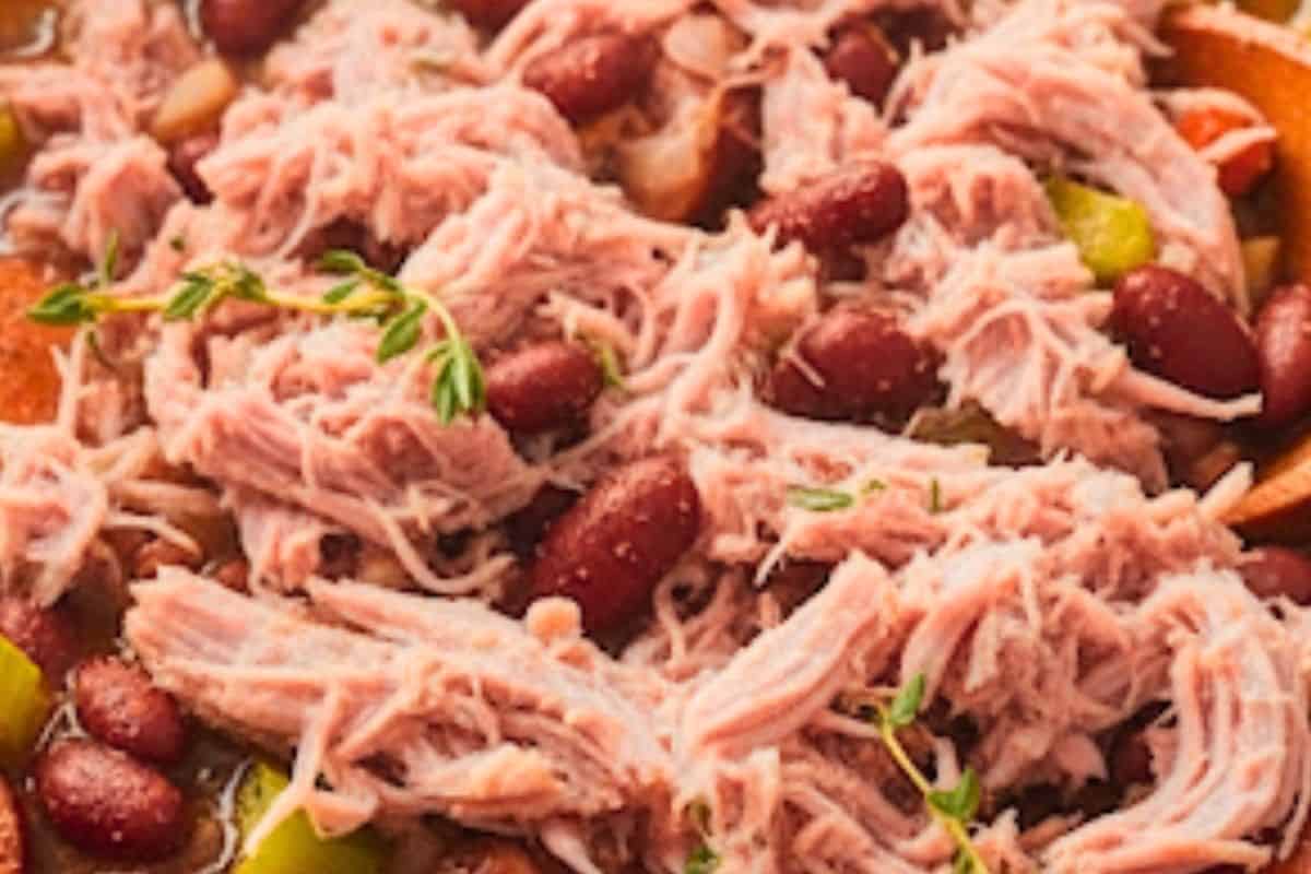 Shred the meat off the bone, discard the bone, and return the meat to the pot.