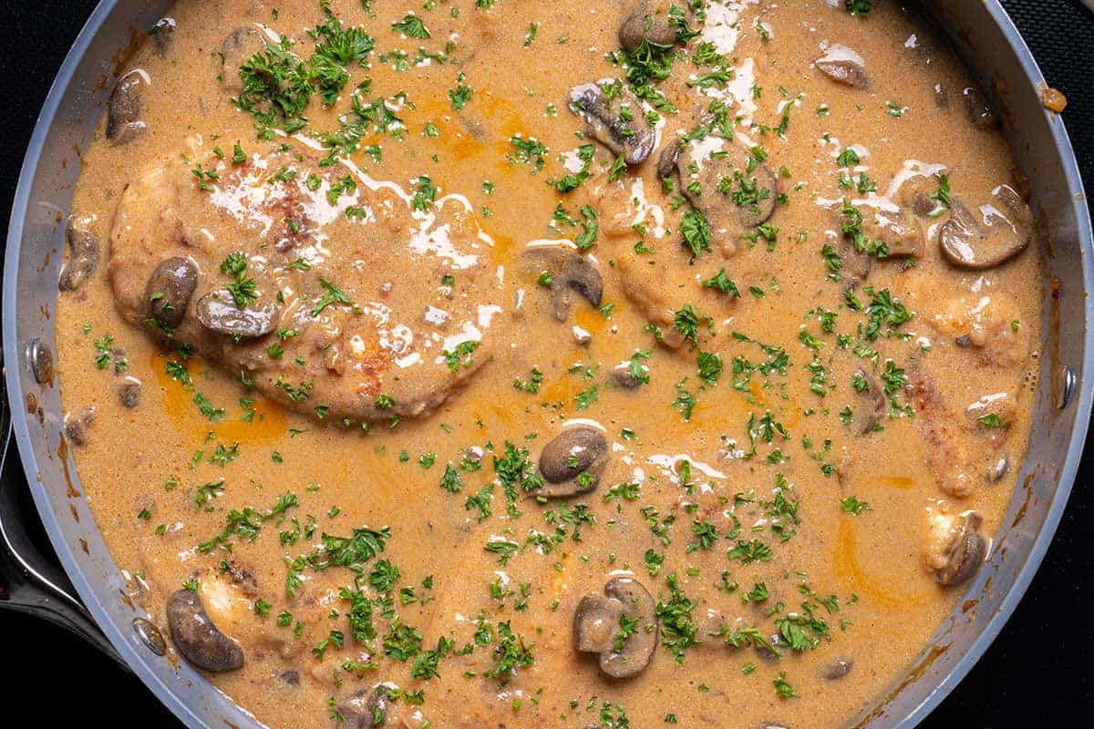 Chicken Stroganoff in a pan garnished with parsley