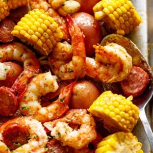 zoom in image of Shrimp boil on a tray with a tablespoon.