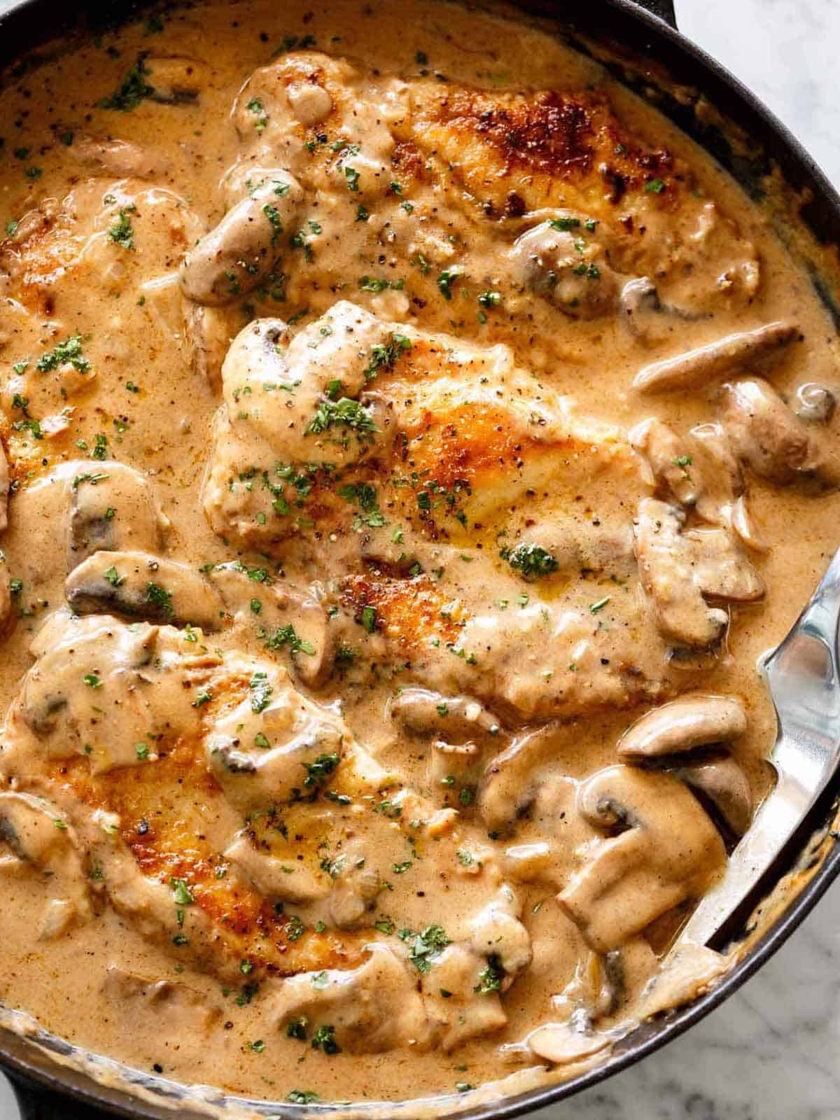 Chicken Stroganoff is just like beef stroganoff, but better! #chicken #chickenbreast #stroganoff #recipe creamy Chicken Stroganoff in a creamy mushroom gravy inside a black pan