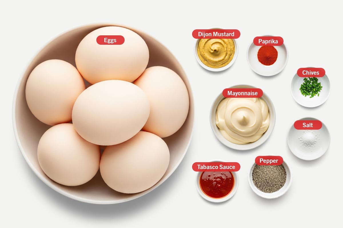 Top shot of ingredients: Eggs, Mayonnaise, Dijon Mustard, Tabasco Sauce, Paprika, Chives, Salt, Pepper.