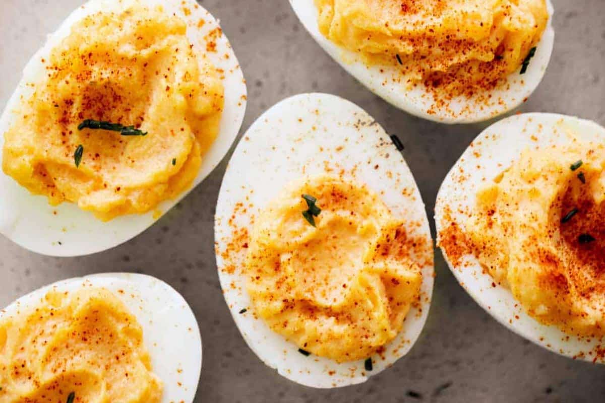 Classic Deviled Eggs dust lightly with paprika and top with extra chopped chives.