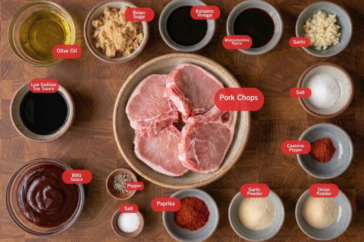 Flat lay photo of ingredient shot of olive oil, brown sugar, balsamic vinegar, worchestire sauce, garlic, salt, cayenne pepper, onion powder, garlic powder, paprika, salt, pepper, bbq sauce, low sodium soy sauce pork chops in making the bbq baked pork chops