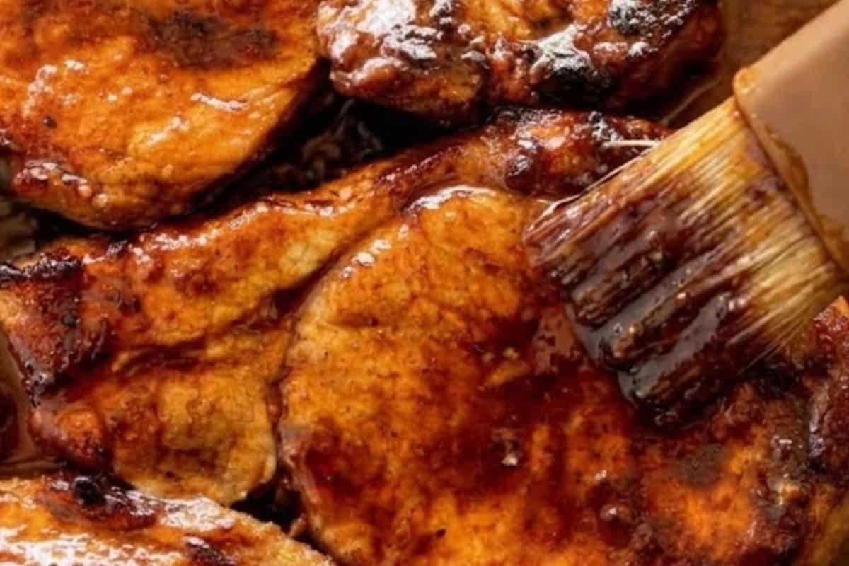 Remove from the oven, flip the chops, and baste with the reserved marinade.