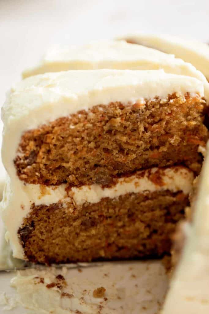 Close up image of the inside of the cake, with thick icing between two layers.