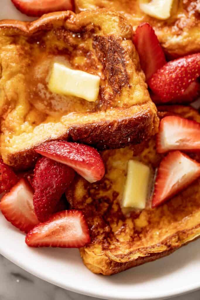 French Toast with maple syrup, butter and strawberries.