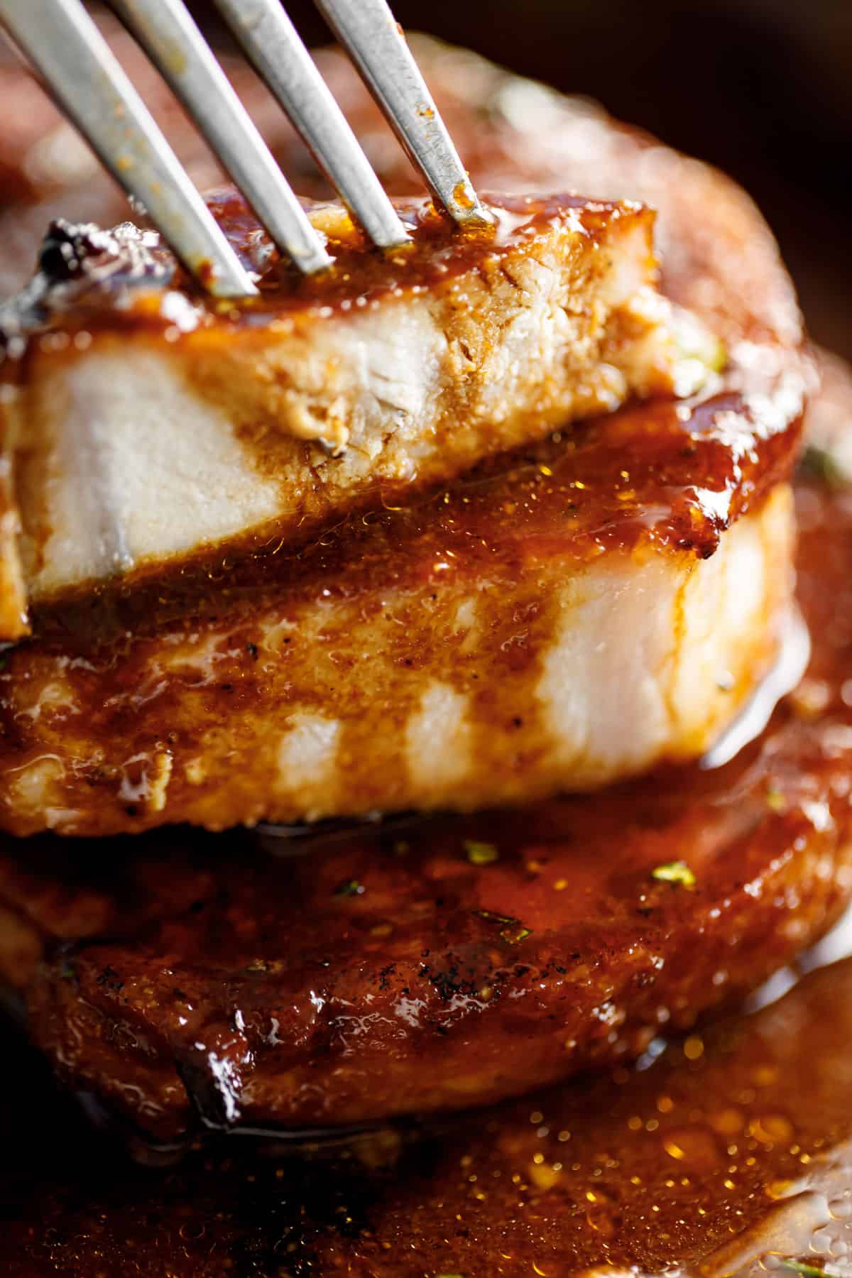 Juicy sliced pork chops drizzled with sauce | cafedelites.com