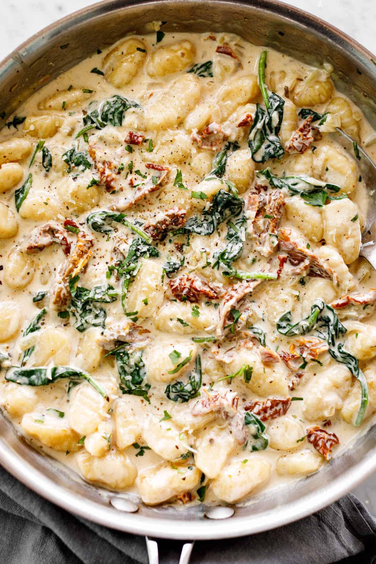 Gnocchi in a skillet with a creamy sun dried tomato sauce | cafedelites.com