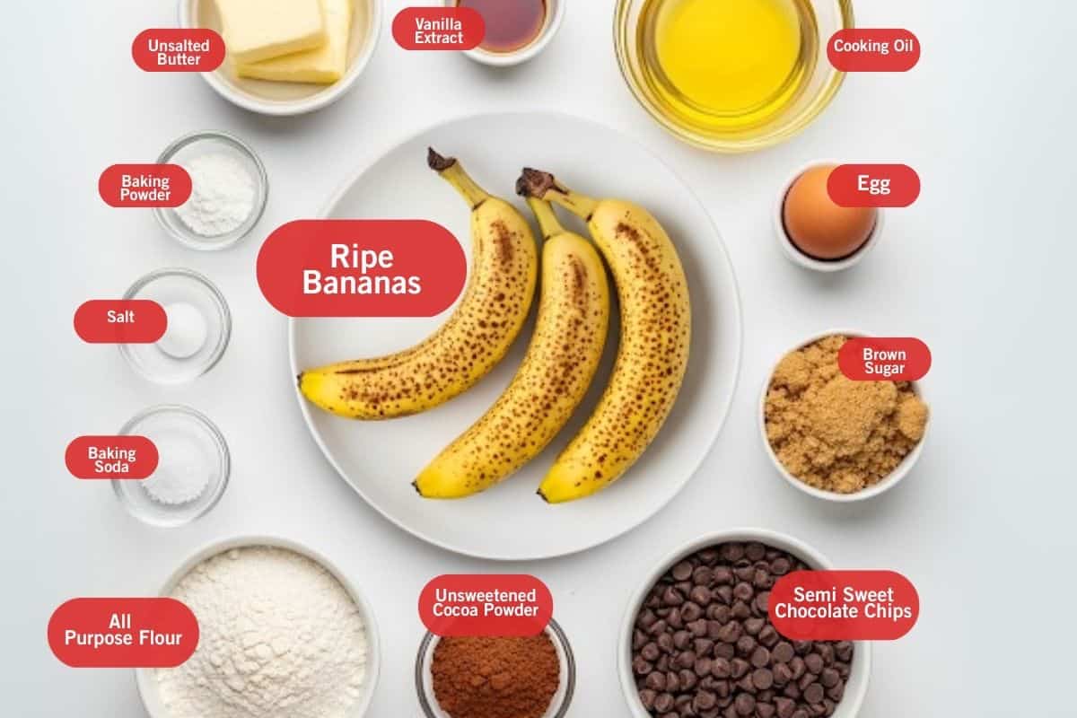 Flat lay photo of ingredient shot of unsalted butter, vanilla extract, cooking oil, egg, brown sugar, semi sweet chocolate chips, unsweetened cocoa powder, all purpose flour, baking soda, salt, baking powder, ripe bananas