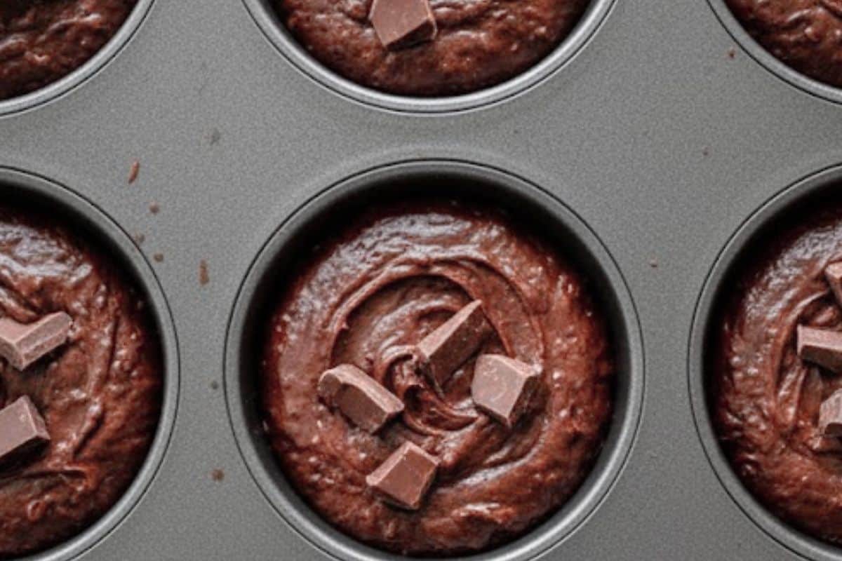 Spoon the batter evenly into the muffin pan, filling each cup just over three-quarters full. Top with the remaining chocolate chunks.