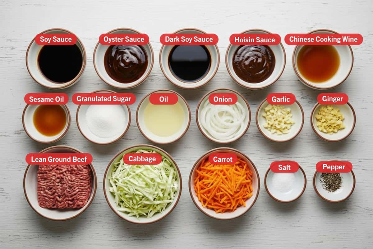 Top shot of ingredients: soy sauce, oyster sauce, dark soy sauce, hoisin sauce, chinese cooking wine, sesame oil, granulated sugar, oil, onion, garlic, ginger, lean ground beef, cabbage, carrot, salt, and pepper.