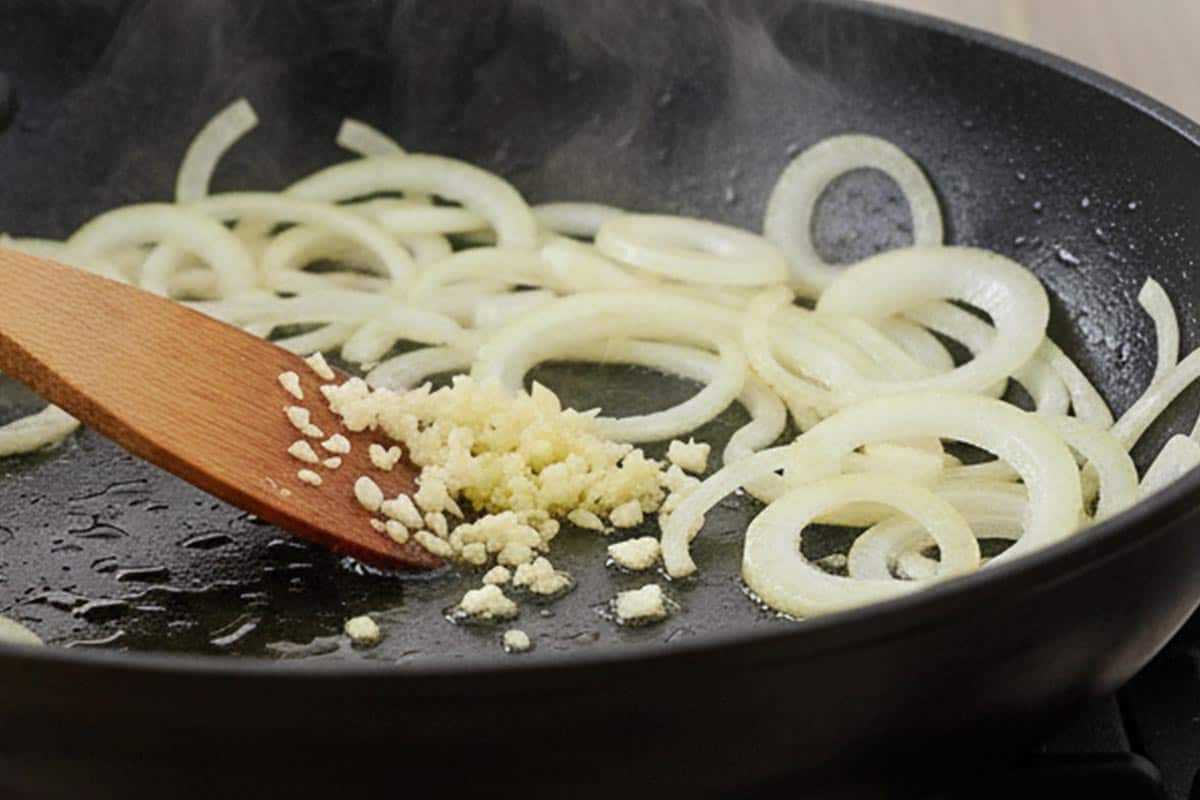 Cooking the onion and garlic in a pan.