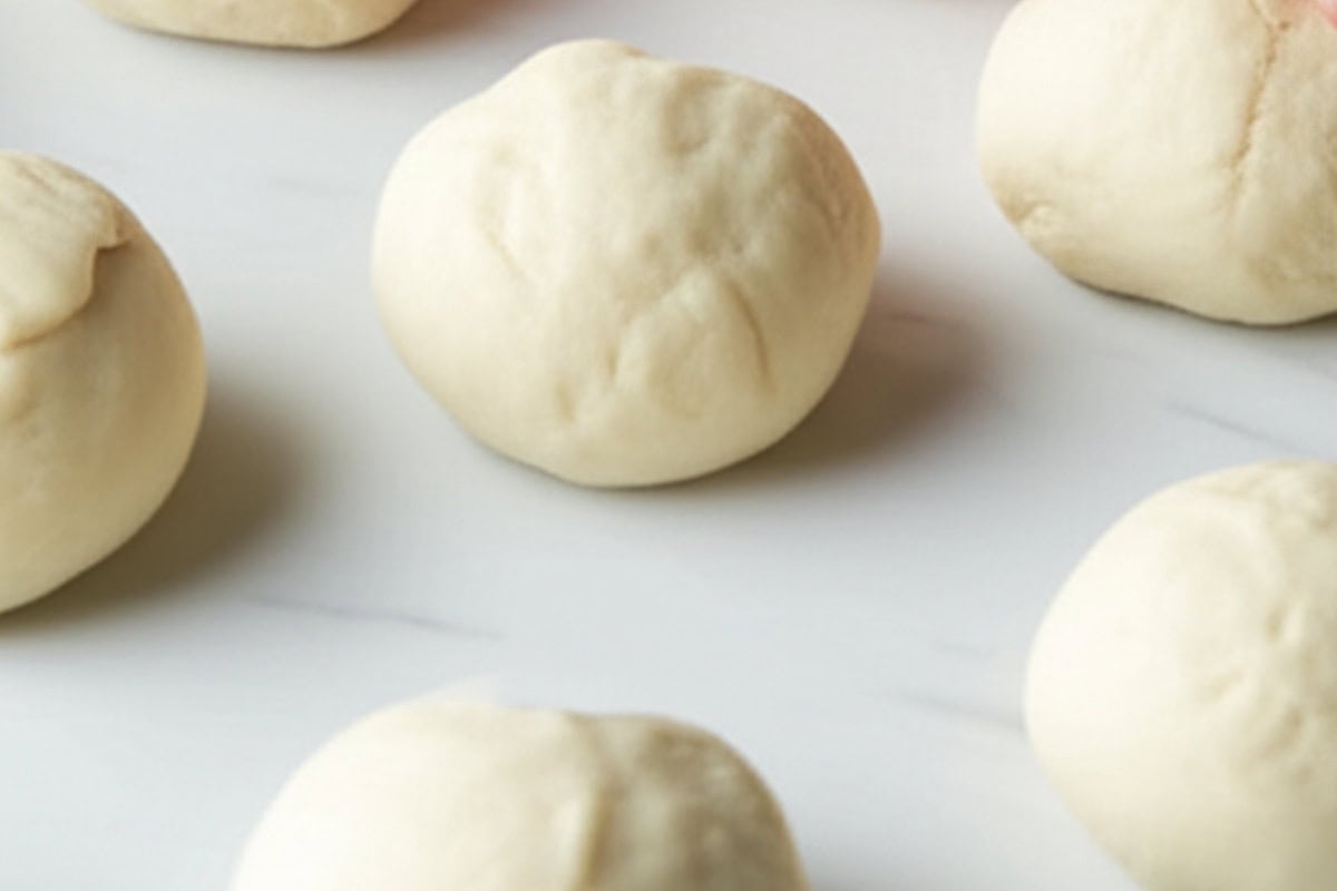 Cut the dough and divide the tortilla dough into equal pieces and shape them into balls.