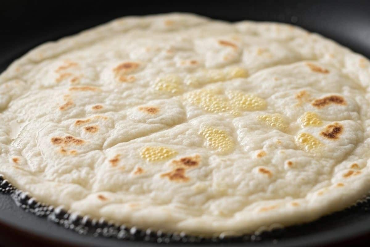 Place the roll out dough in a hot dry pan and cook until bubbles form and golden spots appears