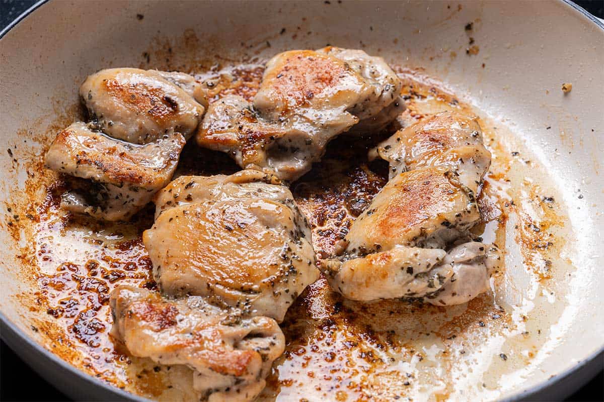 seared chicken thighs in a cream pan