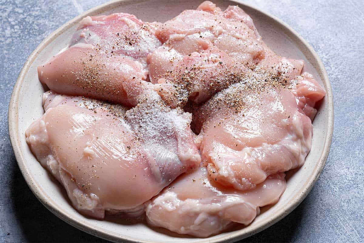 Pat dried chicken thighs and season them with salt and pepper.