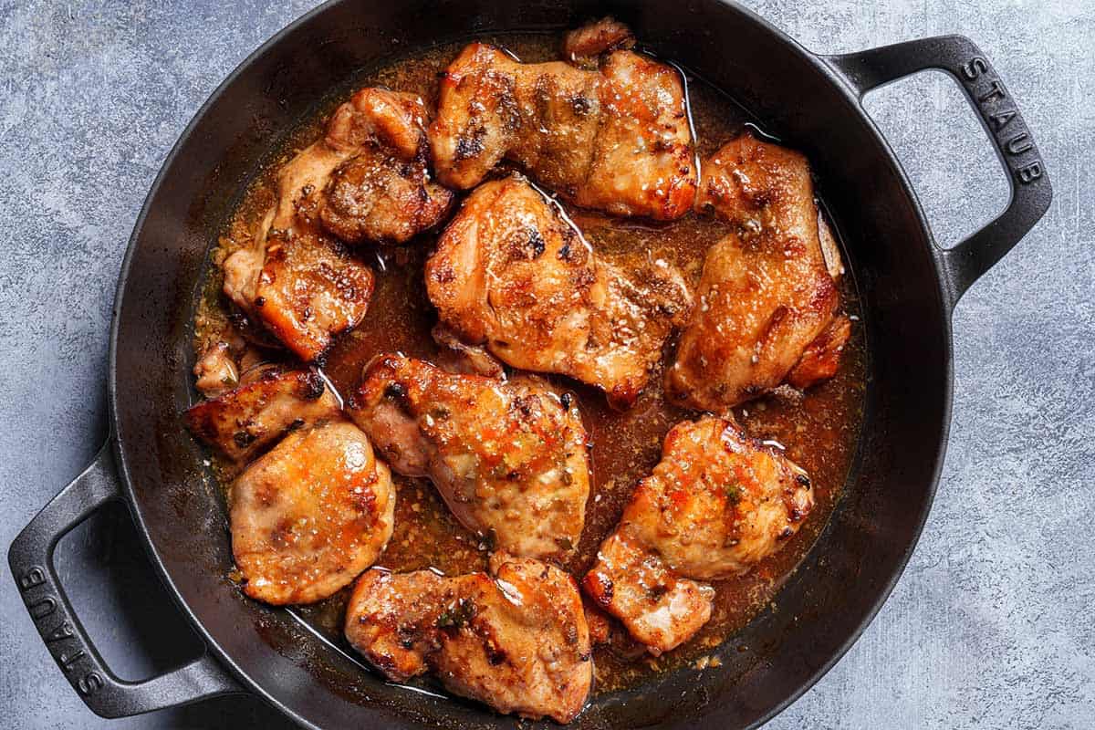 Image of the chicken being taken out of the oven after having been broiled.