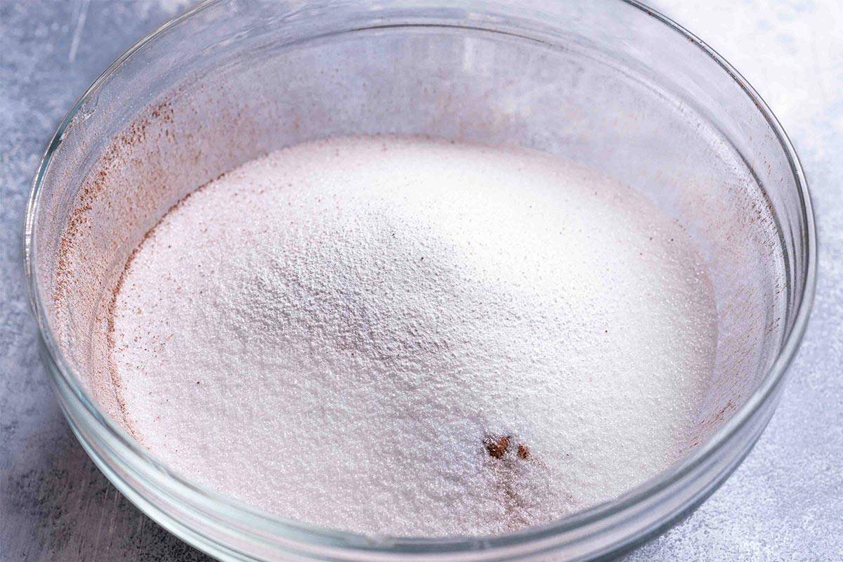 flour, unsweetened cocoa powder, baking powder, baking soda, salt and white granulated sugar unmixed in a clear bowel