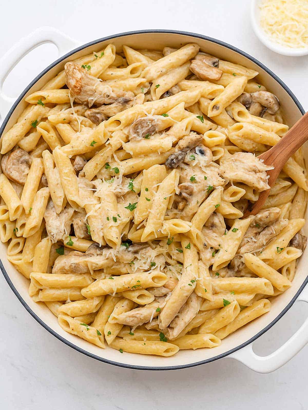 Seared chicken strips mixed through this One-Pot Creamy Mushroom Chicken Pasta, with garlic, mushrooms and parmesan cheese. The pasta is sprinkled with freshly grated parmesan and fresh herbs. 