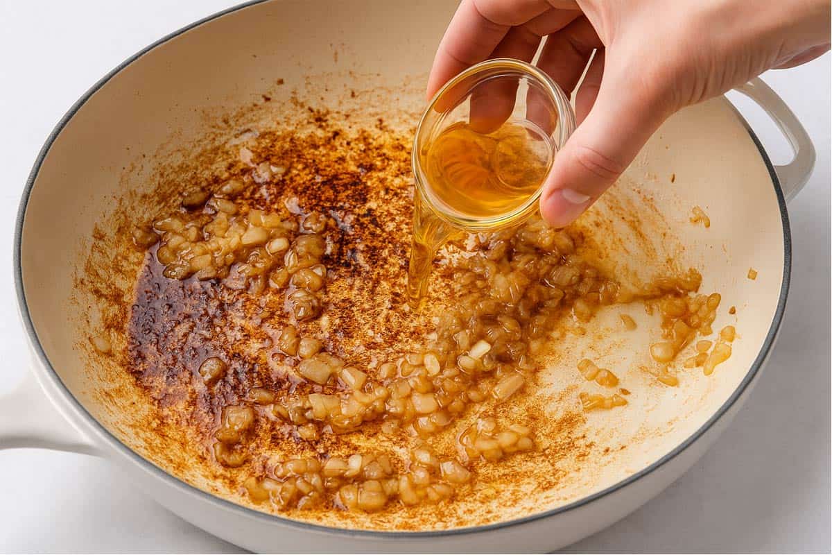 Onion, garlic and browned bits in the cream pan with white wine