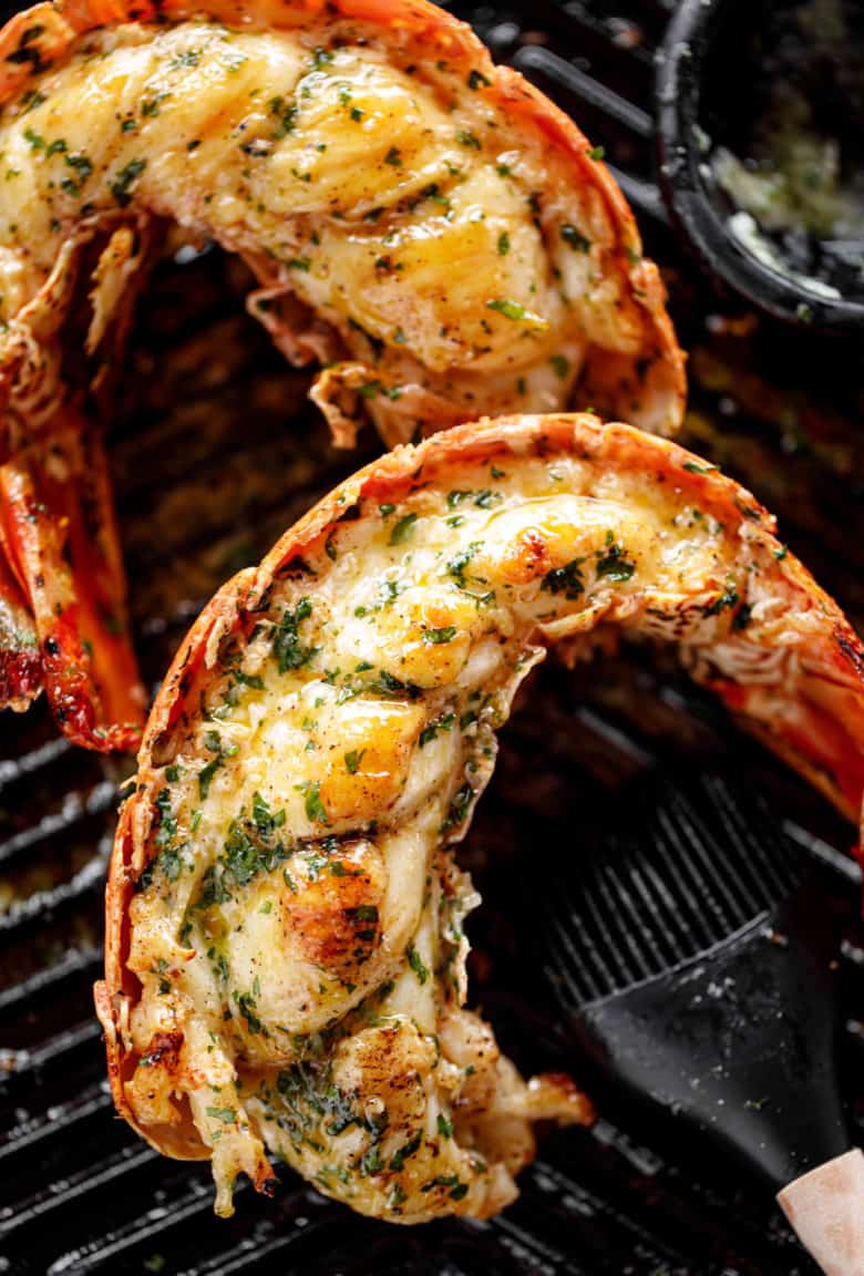Grilled Lobster Tails with melted garlic herb butter on a black grill pan | cafedelites.com