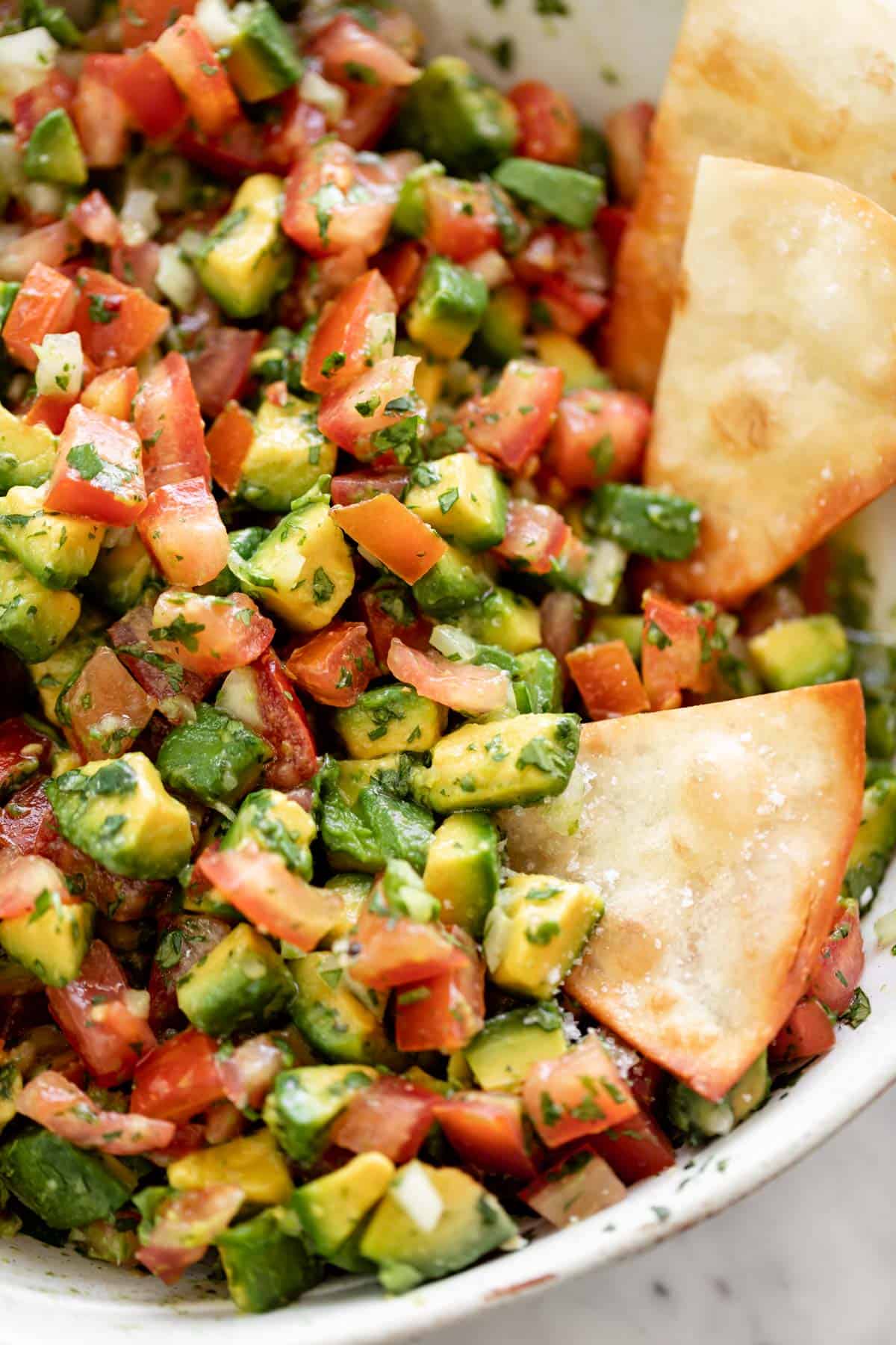 Avocado Salsa with tortilla chips in a bowl | cafedelites.com