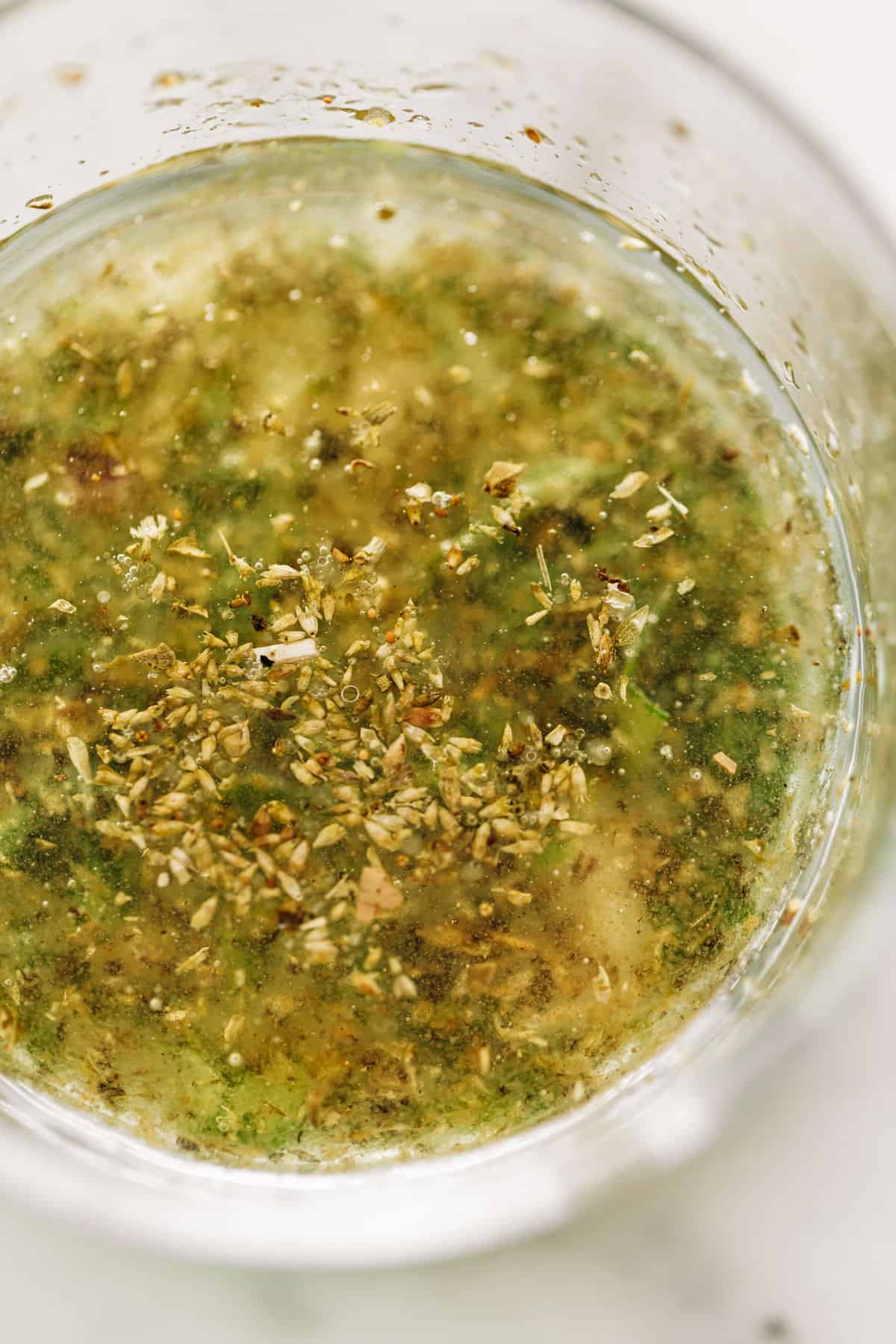 Lemon herb salad dressing in a glass for a Chickpea Tomato Salad | cafedelites
