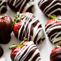 A close up photograph of a chocolate covered strawberry.