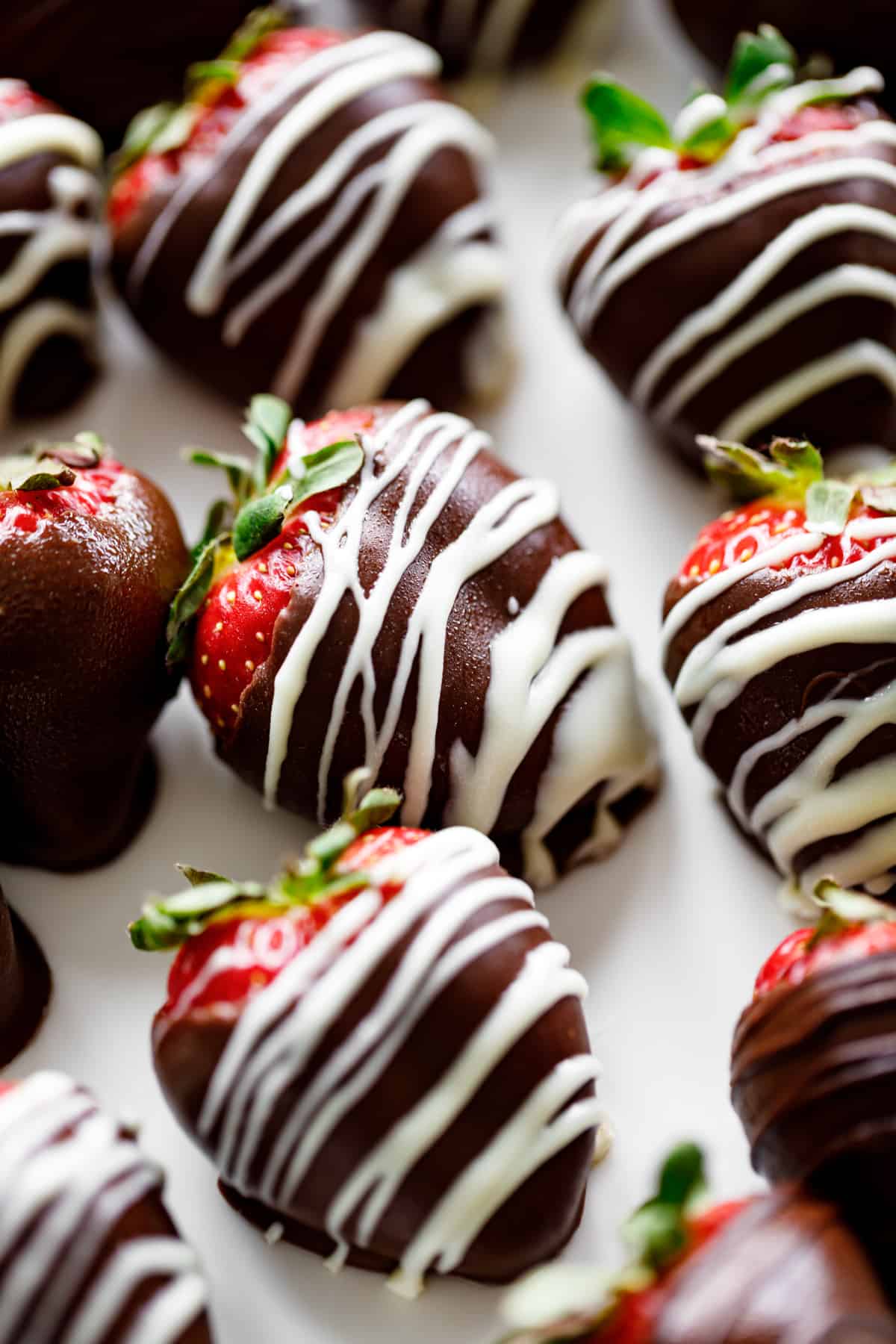 A close up photograph of a chocolate covered strawberry.