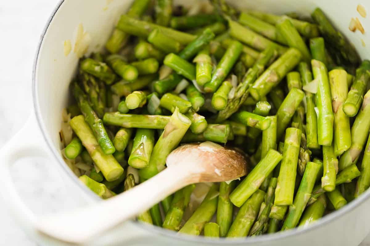 Cut up asparagus and mixed in butter in a white pot with a wooden spoon.