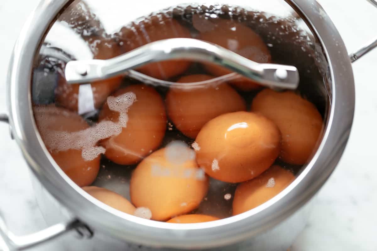 12 eggs in a pot of boiling water covered with a lid and taken off the heat.