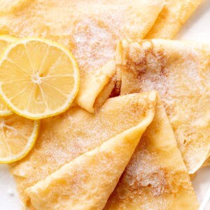 3 crepes with lemon slices and caster sugar