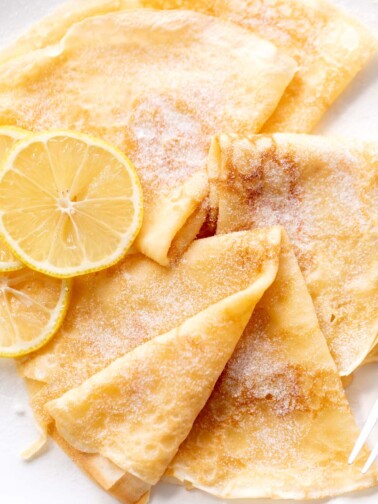3 crepes with lemon slices and caster sugar