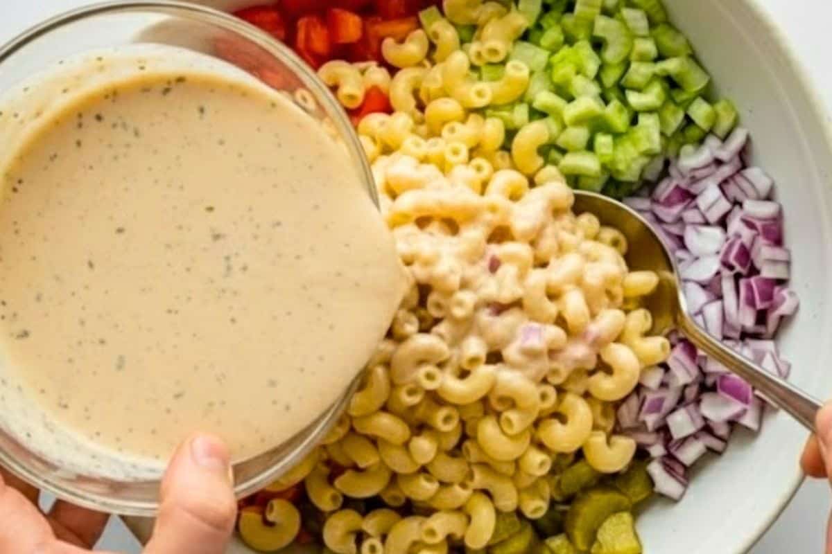 Add pasta to the bowl with vegetables, pour over dressing, and toss until coated.