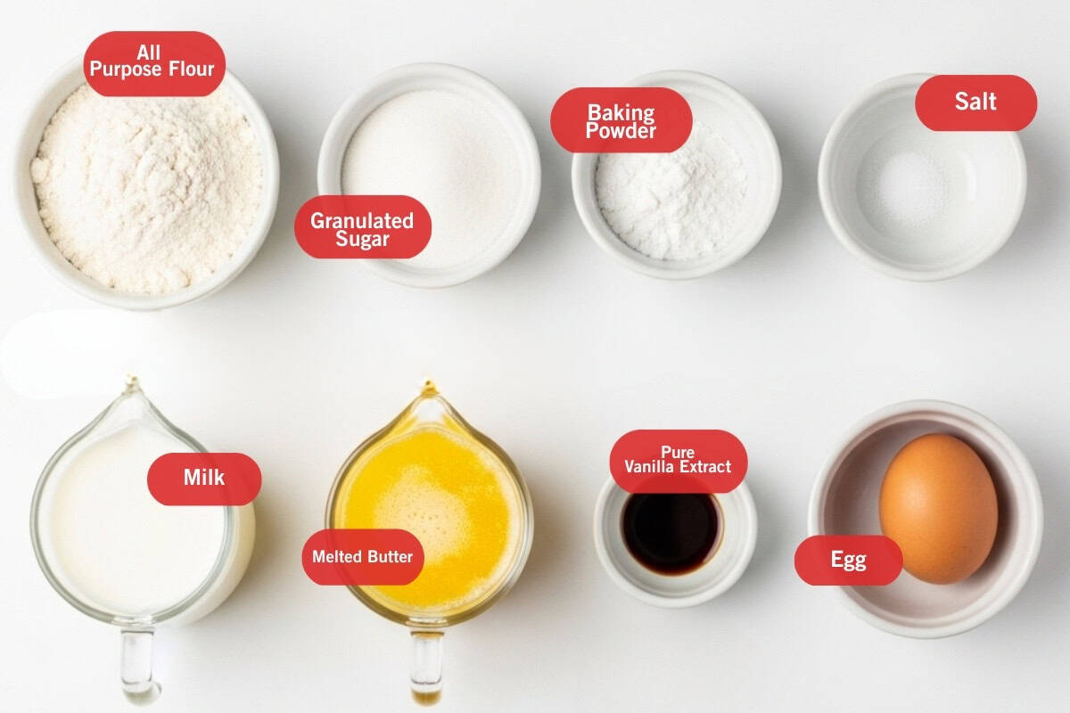 Flat lay photo of ingredient shot of all purpose flour, granulated sugar, baking powder, salt, milk, melted butter, pure vanilla extract, egg