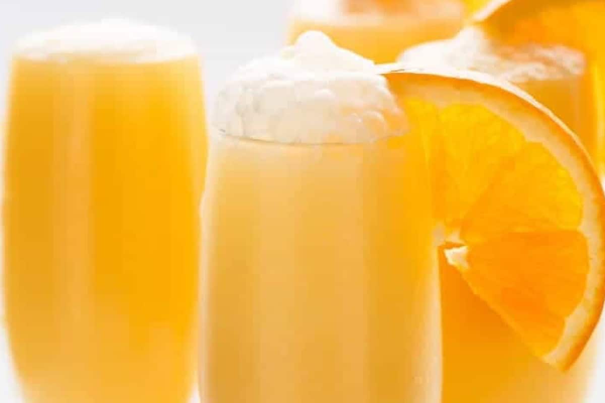 Fill glass halfway with orange mixture. Top with chilled Champagne, add about 1/2 teaspoon orange liqueur to each glass, and finish with an orange slice.
