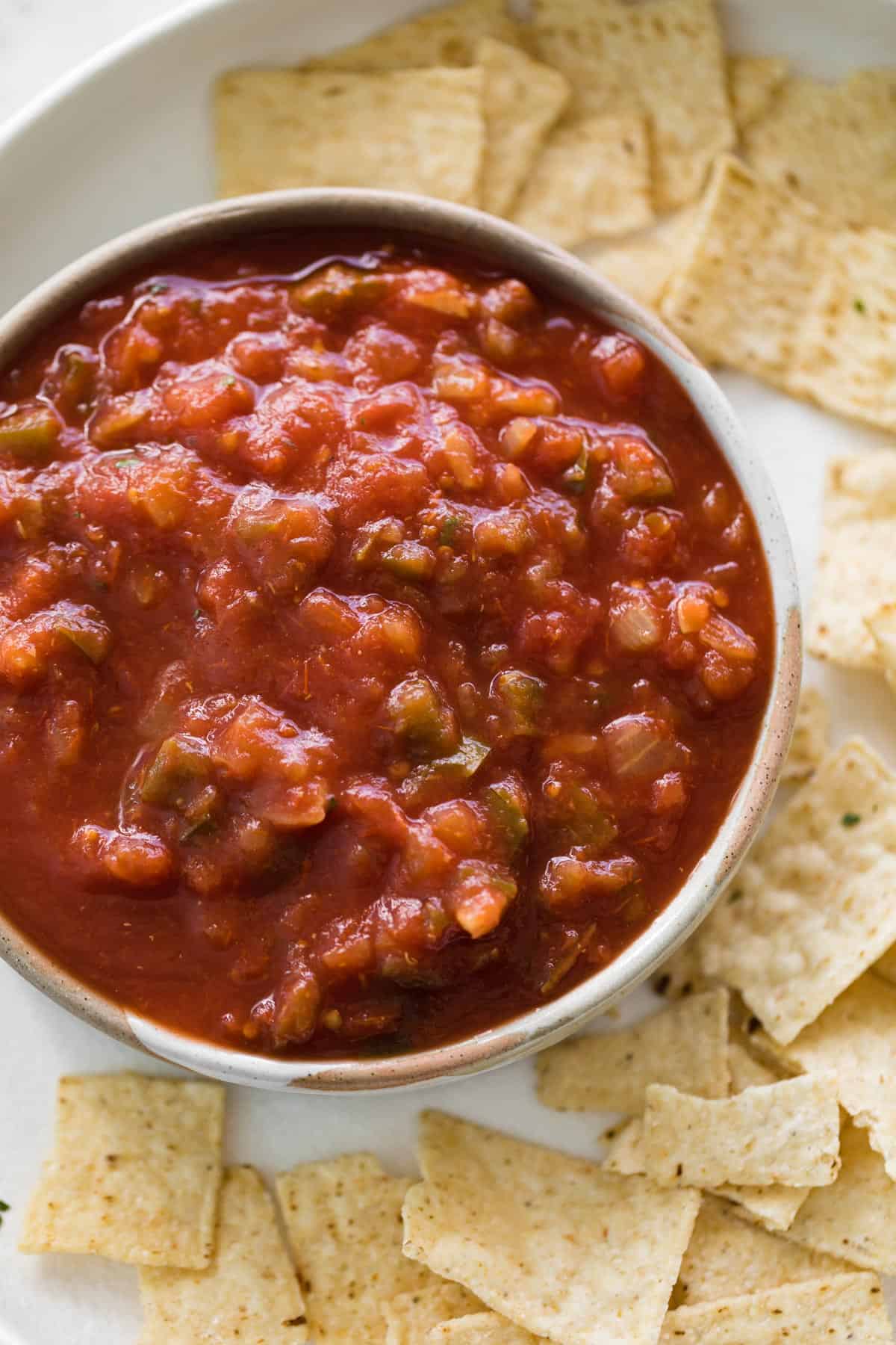 Homemade salsa in a bowl served with corn chips.