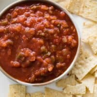 A bowl of homemade salsa made with tomatoes, onion, garlic, Serrano peppers, jalapeños, garlic, cumin and oregano | cafedelites.com