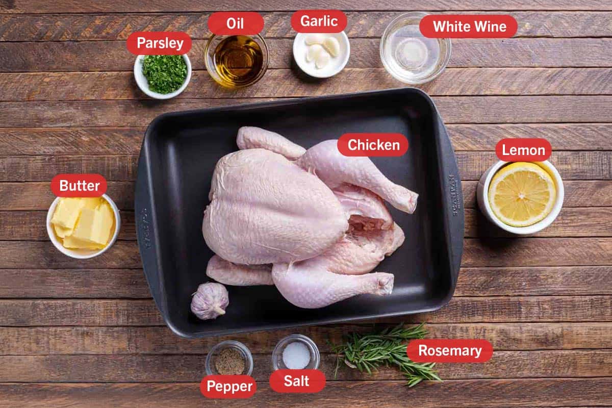 Image of the ingredients needed to prepare garlic herb roast chicken, specifically: butter, chicken, parsley, oil, garlic, white wine, lemon, rosemary, salt , and pepper.