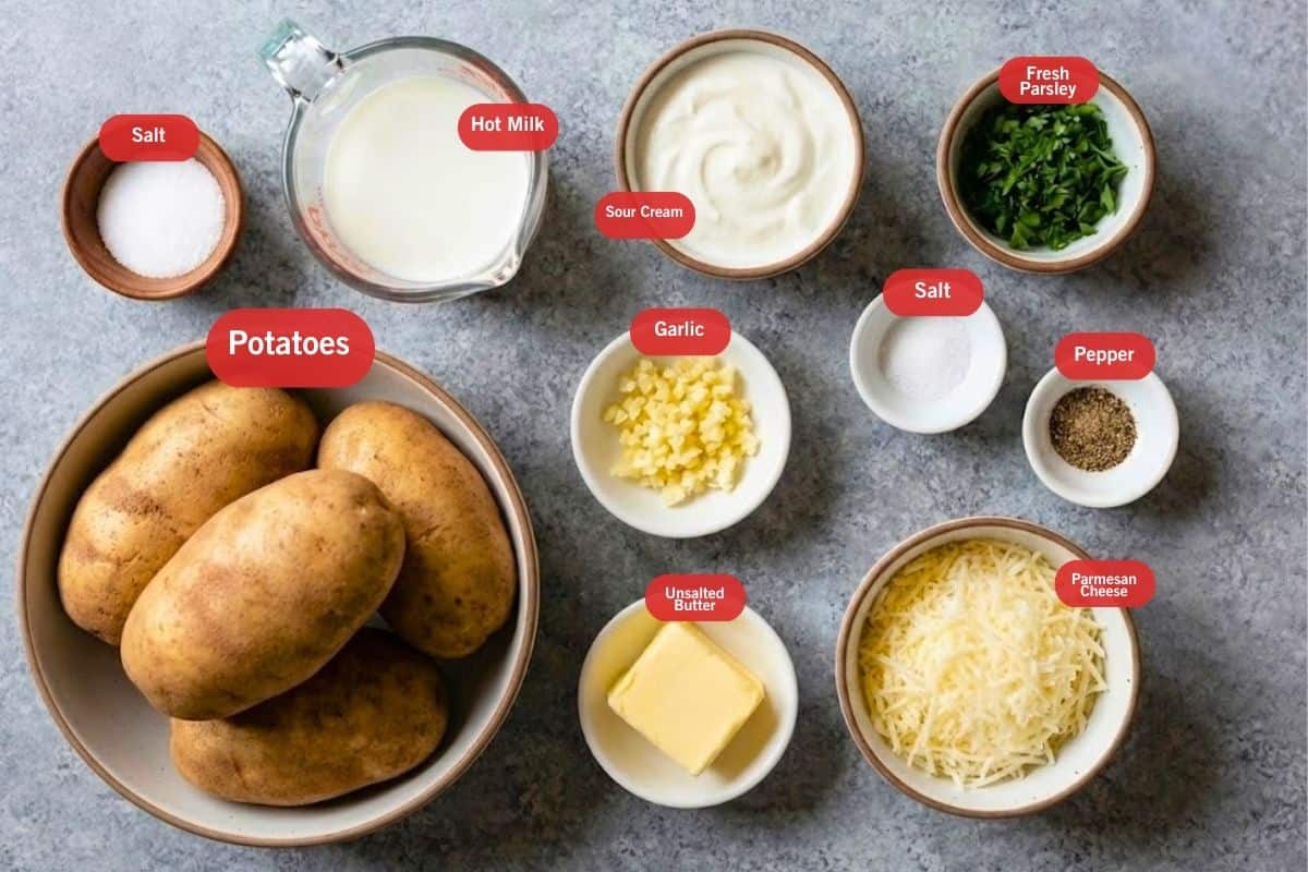 Flat lay photo of salt, potatoes, hot milk, sour cream, fresh parsley, unsalted butter, parmesan cheese, salt, pepper