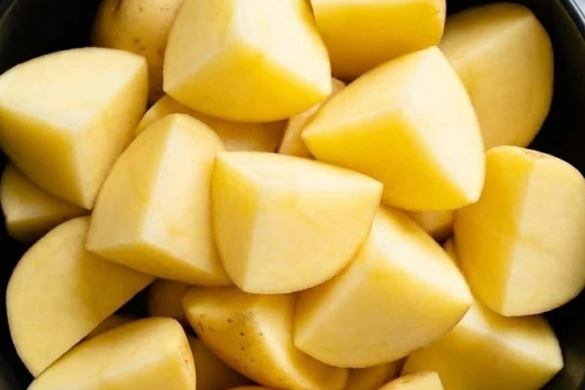 Peel and cut potatoes into quarters