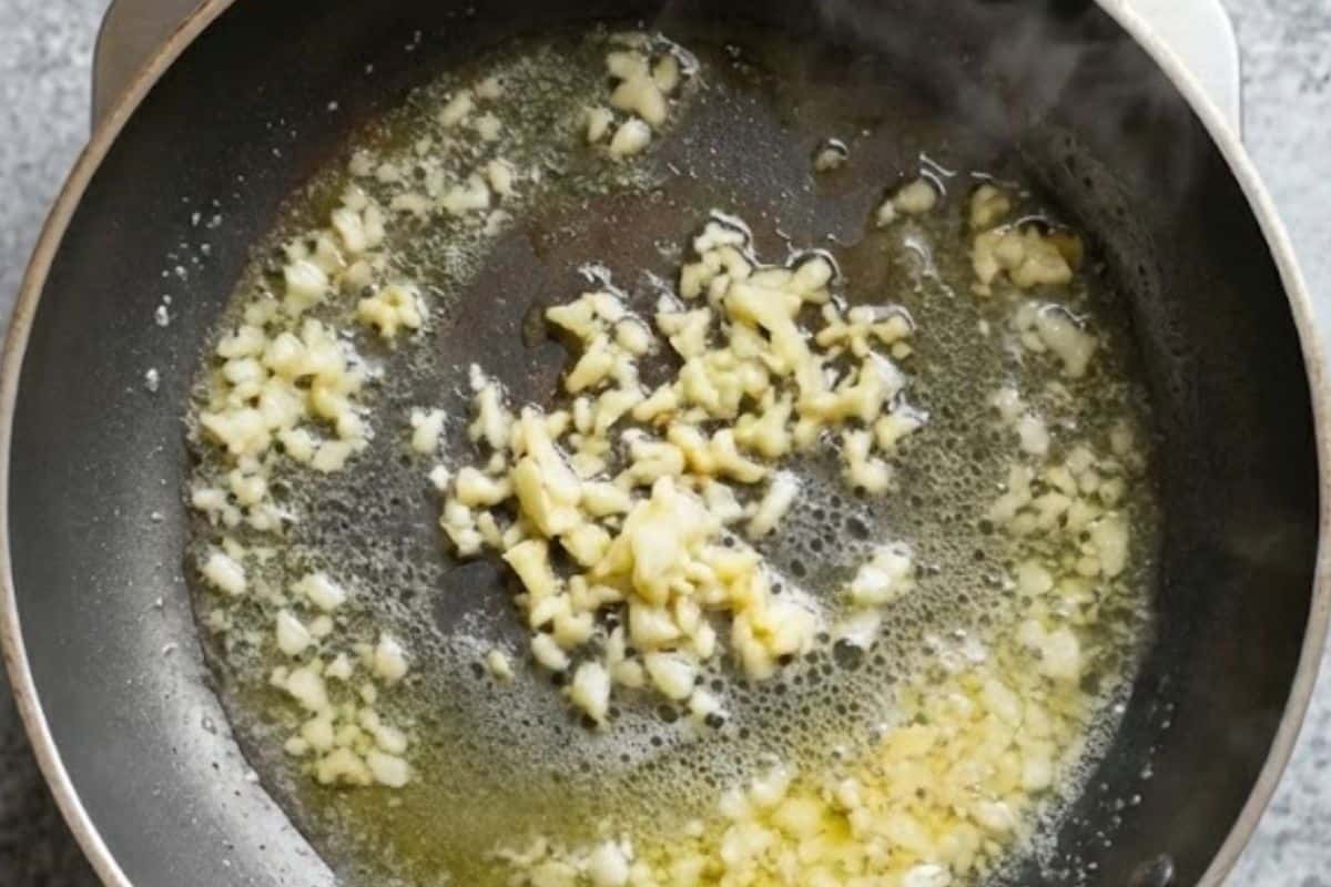 Melt 1 tablespoon of butter in a small pan over medium heat and cook the garlic