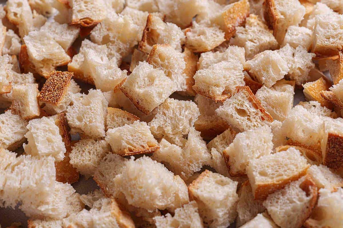 Step 1: The image shows finely diced pieces of stale bread ready to be used for making the stuffing.