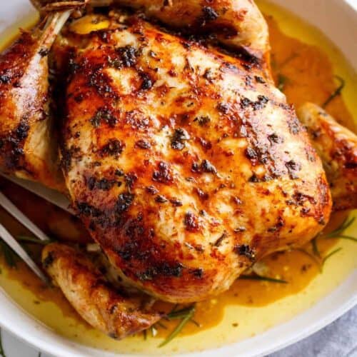 An image of golden garlic herb butter chicken just taken out of the oven and ready to be served.