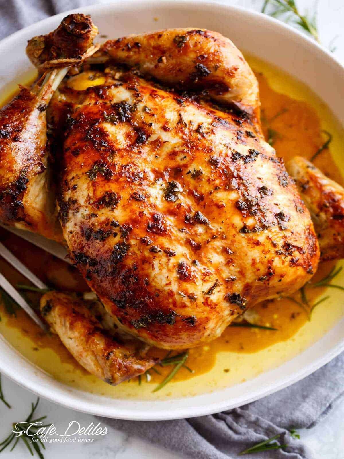 An image of golden garlic herb butter chicken just taken out of the oven and ready to be served.