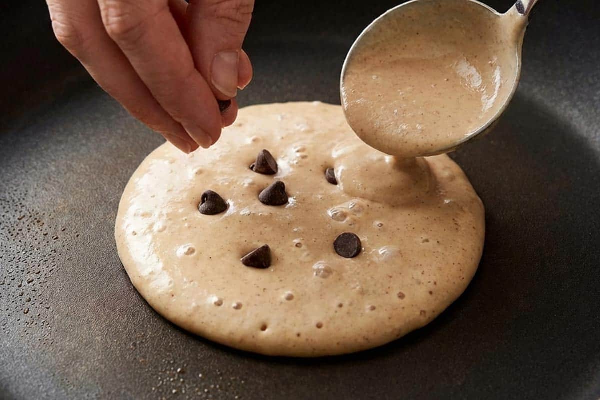 Cooking the batter and putting chocolate chips into the center. - 7